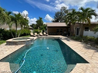 view of swimming pool with an in ground hot tub and a patio