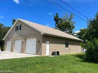 view of property exterior featuring a garage and a yard