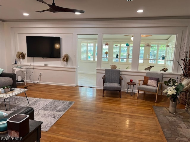 living room featuring light hardwood / wood-style floors and ceiling fan