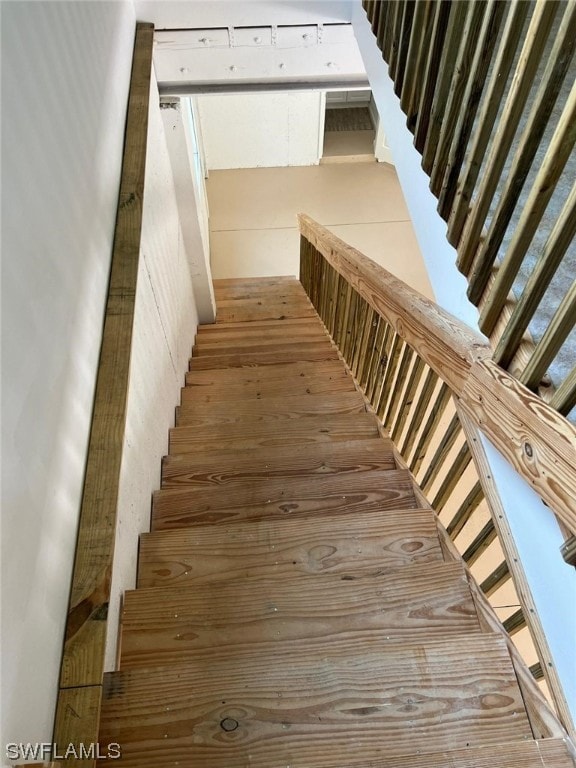 stairs featuring hardwood / wood-style floors