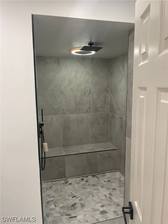 bathroom with tiled shower