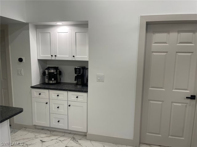 kitchen with white cabinets and light tile floors