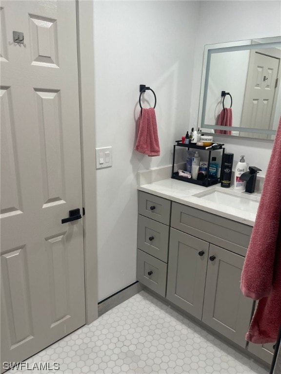 bathroom with tile flooring and vanity