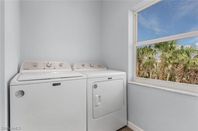 laundry area with independent washer and dryer