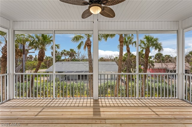 unfurnished sunroom featuring ceiling fan