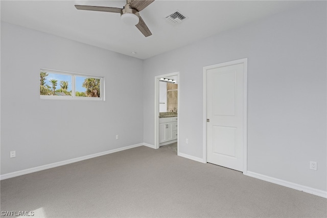 unfurnished bedroom featuring ensuite bathroom, ceiling fan, and light carpet