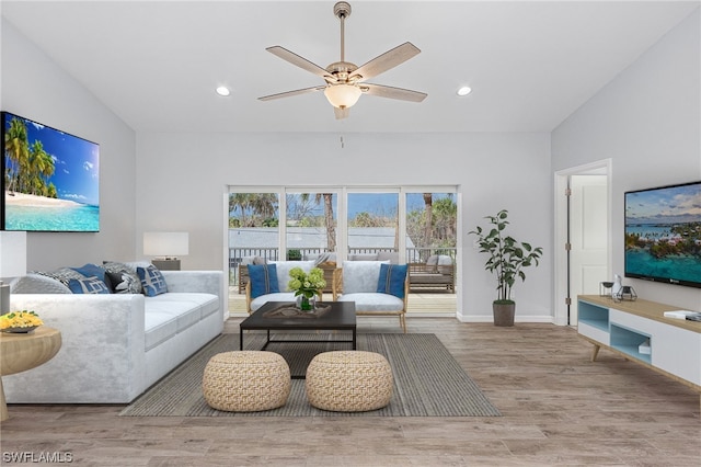 living room featuring ceiling fan, vaulted ceiling, and hardwood / wood-style flooring