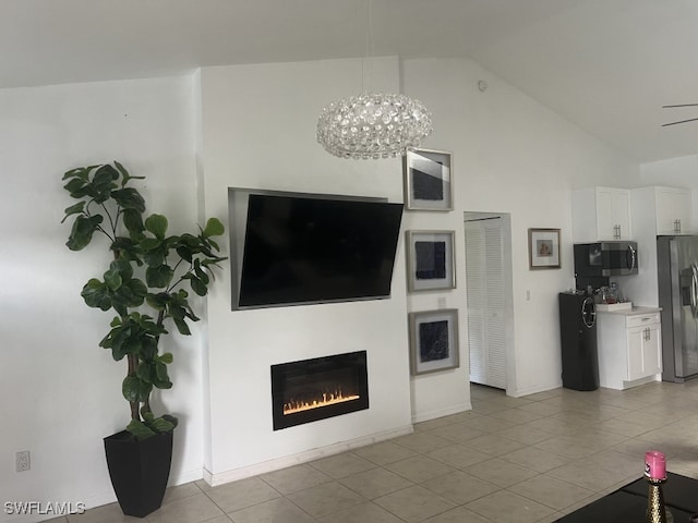 tiled living room featuring vaulted ceiling and an inviting chandelier