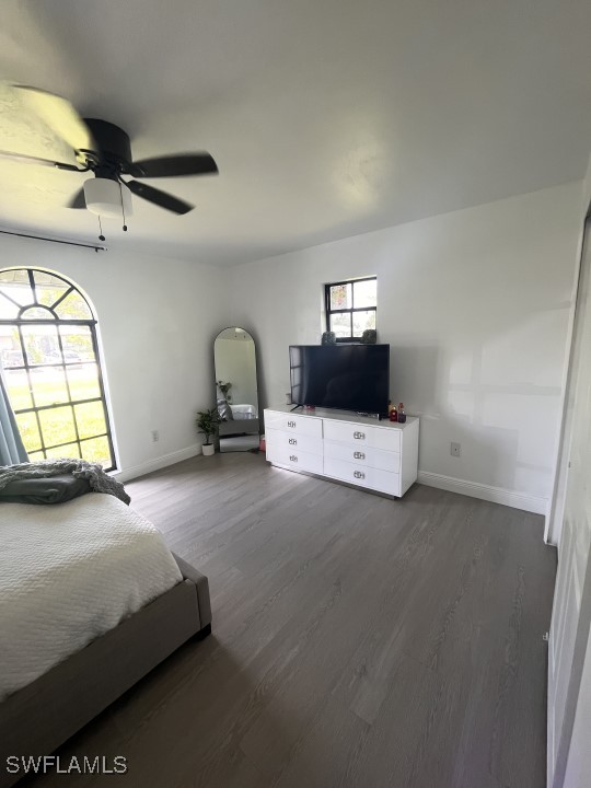 unfurnished bedroom featuring dark wood-type flooring and ceiling fan