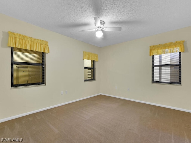 carpeted empty room featuring a textured ceiling and ceiling fan