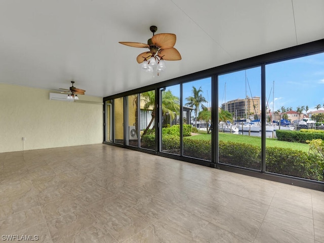 spare room featuring light tile flooring, floor to ceiling windows, and ceiling fan