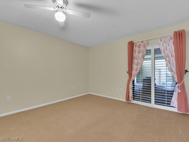 unfurnished room featuring a textured ceiling, carpet floors, and ceiling fan