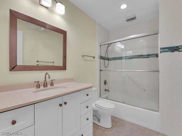 full bathroom featuring vanity, combined bath / shower with glass door, tile floors, and toilet