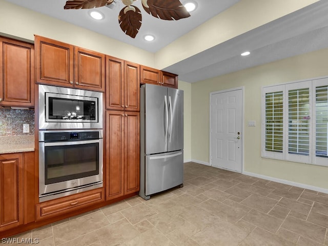 kitchen with ceiling fan, light stone counters, appliances with stainless steel finishes, backsplash, and light tile flooring