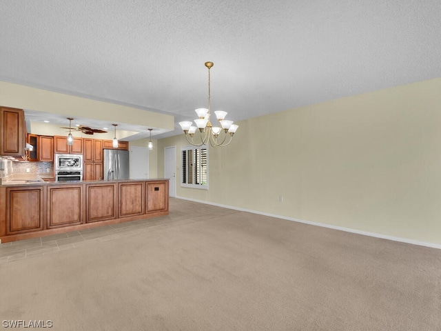 unfurnished living room featuring light carpet, a textured ceiling, and ceiling fan with notable chandelier