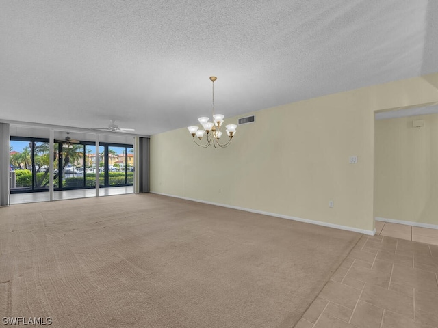 empty room featuring light tile floors, a textured ceiling, and ceiling fan with notable chandelier