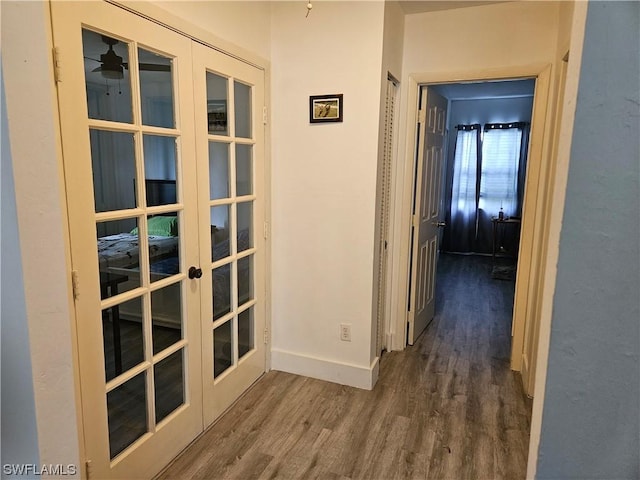 corridor featuring french doors and dark hardwood / wood-style floors