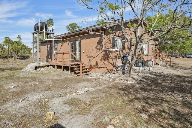 back of property featuring a deck and french doors