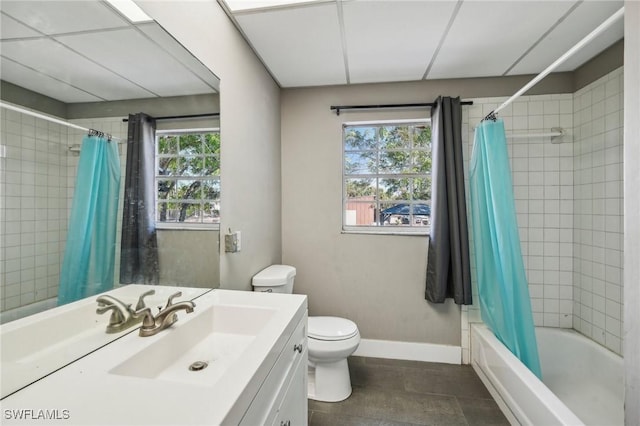 full bathroom featuring vanity, shower / bathtub combination with curtain, and toilet