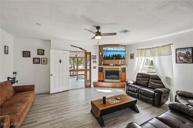 living room with ceiling fan and light hardwood / wood-style flooring