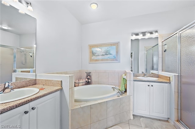 bathroom featuring tile flooring, plus walk in shower, and vanity