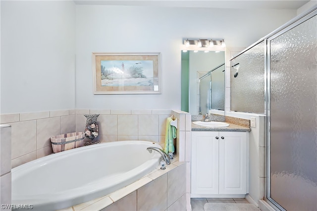 bathroom featuring tile flooring, oversized vanity, and shower with separate bathtub