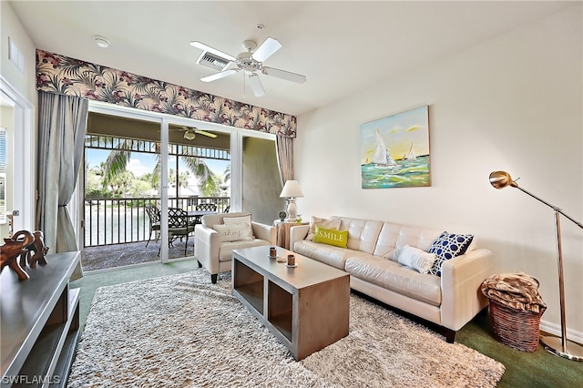 carpeted living room with ceiling fan