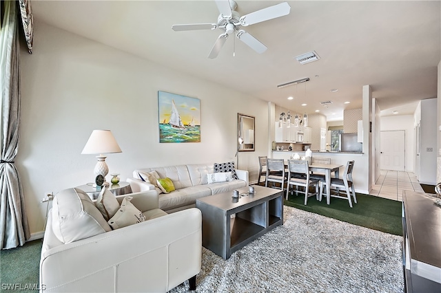 tiled living room with ceiling fan