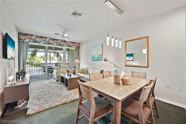 carpeted dining room with ceiling fan