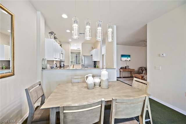 dining area featuring carpet floors and ceiling fan