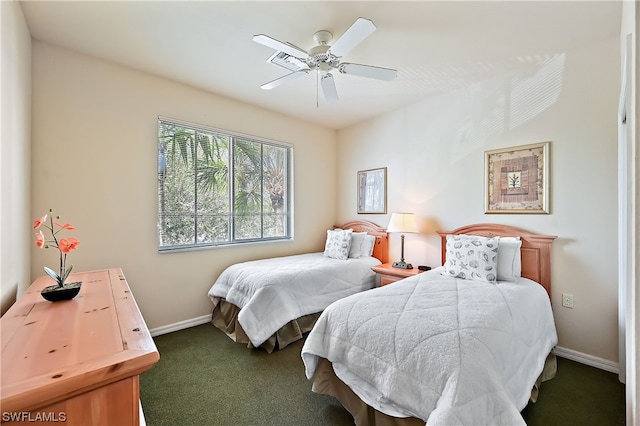 bedroom with ceiling fan and dark colored carpet