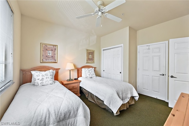 bedroom with ceiling fan and dark carpet