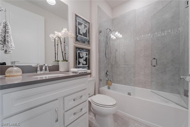 full bathroom with vanity, shower / bath combination with glass door, and toilet