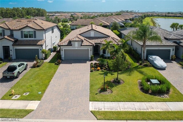 view of front of home with a garage and a water view