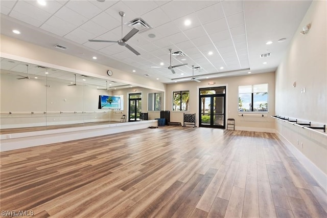 workout room featuring hardwood / wood-style flooring and ceiling fan