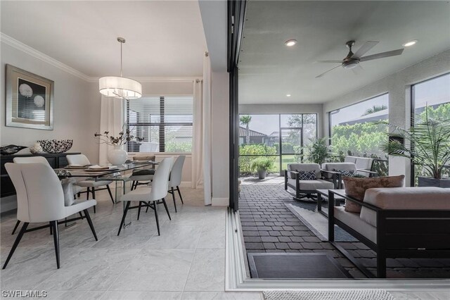 sunroom featuring ceiling fan and a wealth of natural light