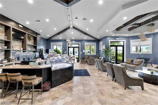 kitchen with french doors, beamed ceiling, a large island, and pendant lighting