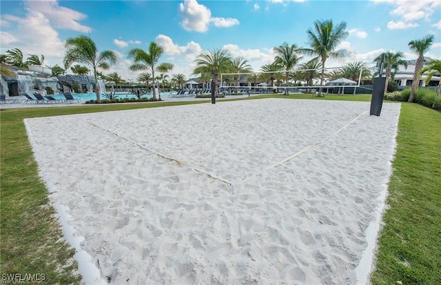 surrounding community featuring volleyball court and a lawn