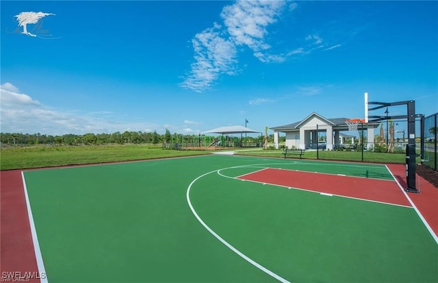 view of sport court with a yard