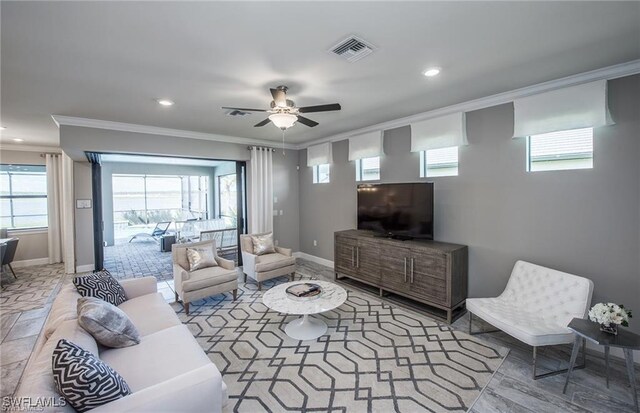 living room with ceiling fan and crown molding