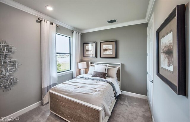 carpeted bedroom featuring crown molding