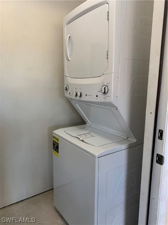 laundry area with stacked washing maching and dryer