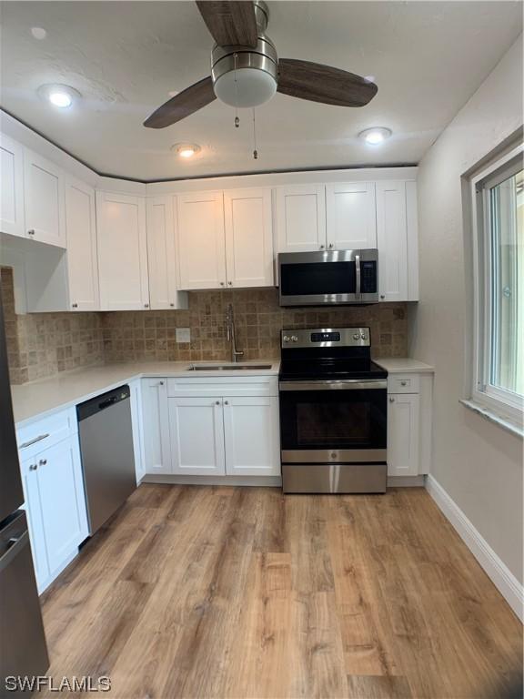 kitchen featuring sink, white cabinets, and stainless steel appliances