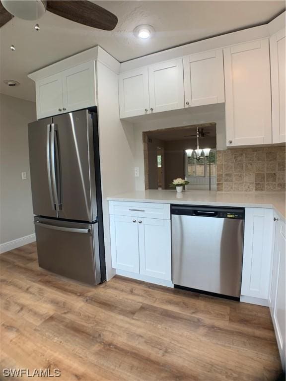 kitchen featuring white cabinetry, ceiling fan, light hardwood / wood-style flooring, backsplash, and appliances with stainless steel finishes