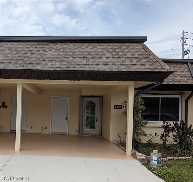 entrance to property featuring a carport