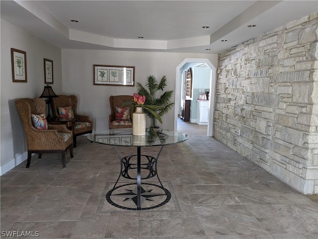 hallway featuring a tray ceiling