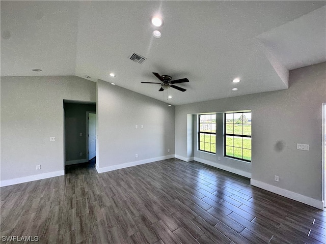 unfurnished room featuring ceiling fan, vaulted ceiling, dark wood-type flooring, and a textured ceiling