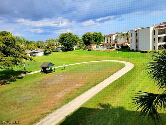 view of property's community with a yard