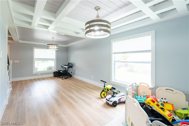 game room featuring light hardwood / wood-style floors, coffered ceiling, a chandelier, and beamed ceiling