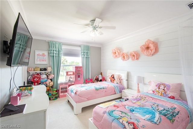 bedroom with light carpet, ornamental molding, and ceiling fan